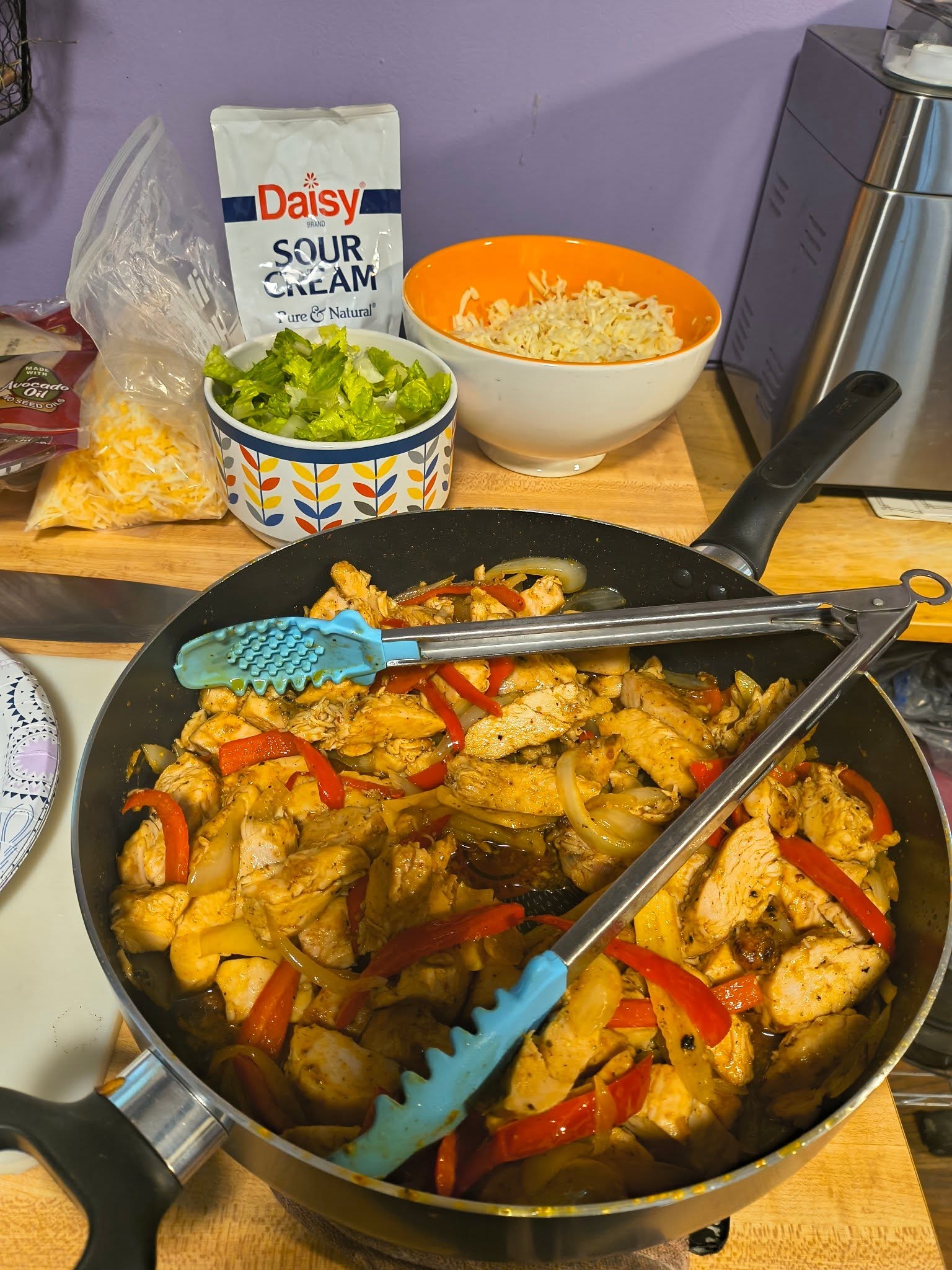 A skillet of colorful peppers, onions, and sliced meat prepared for fajitas